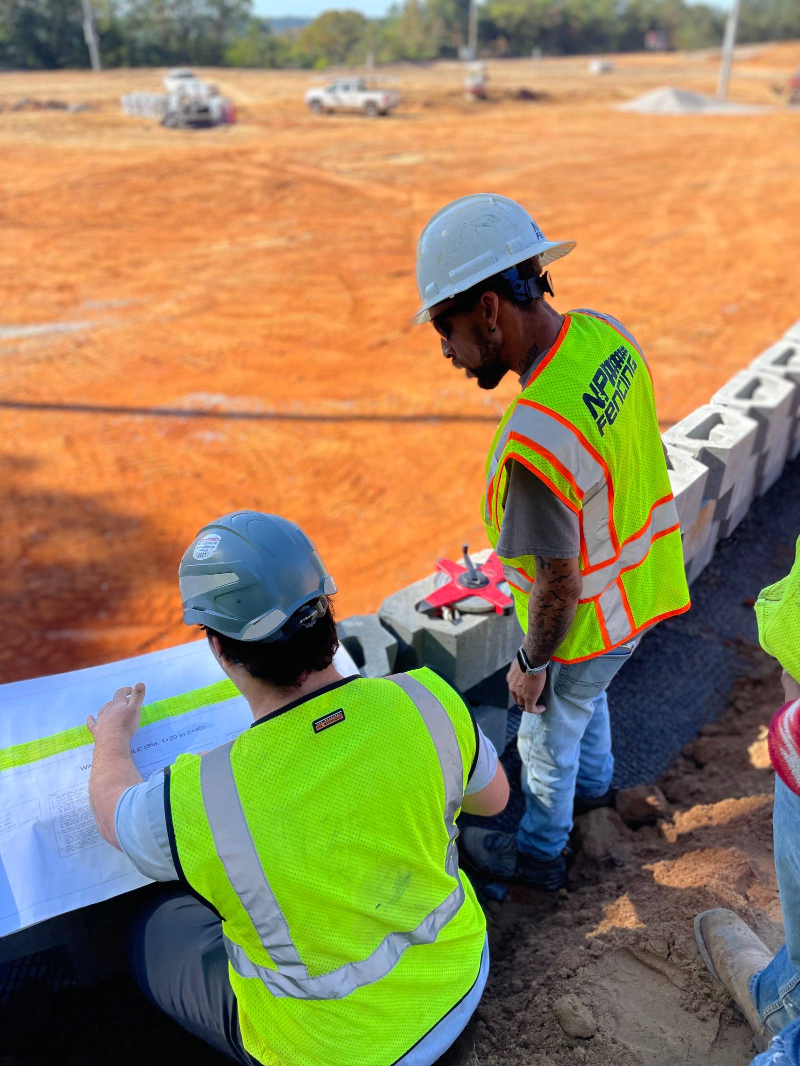 N&P Fencing crew reviewing plans on site